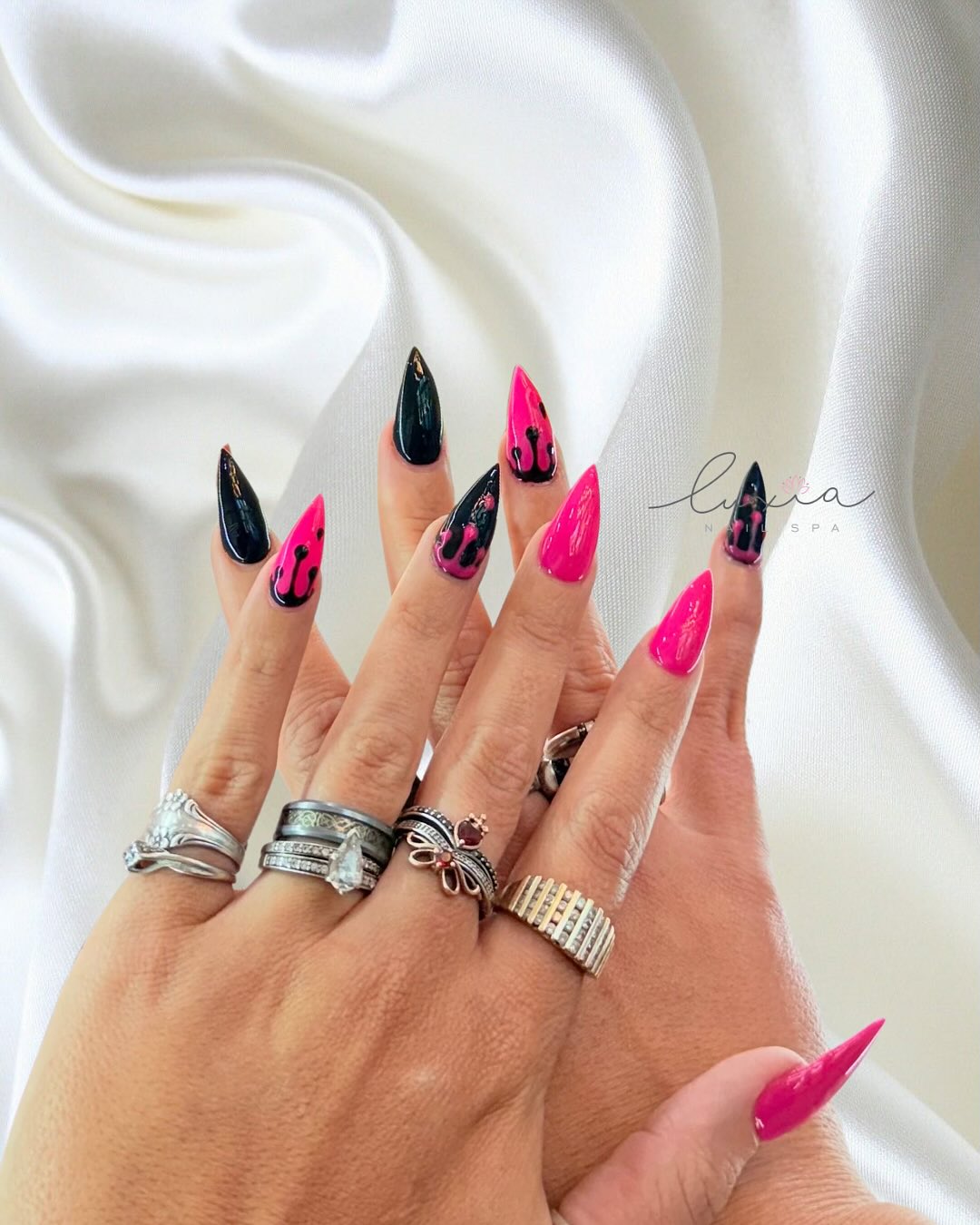 Hot pink and black drip effect stiletto nails