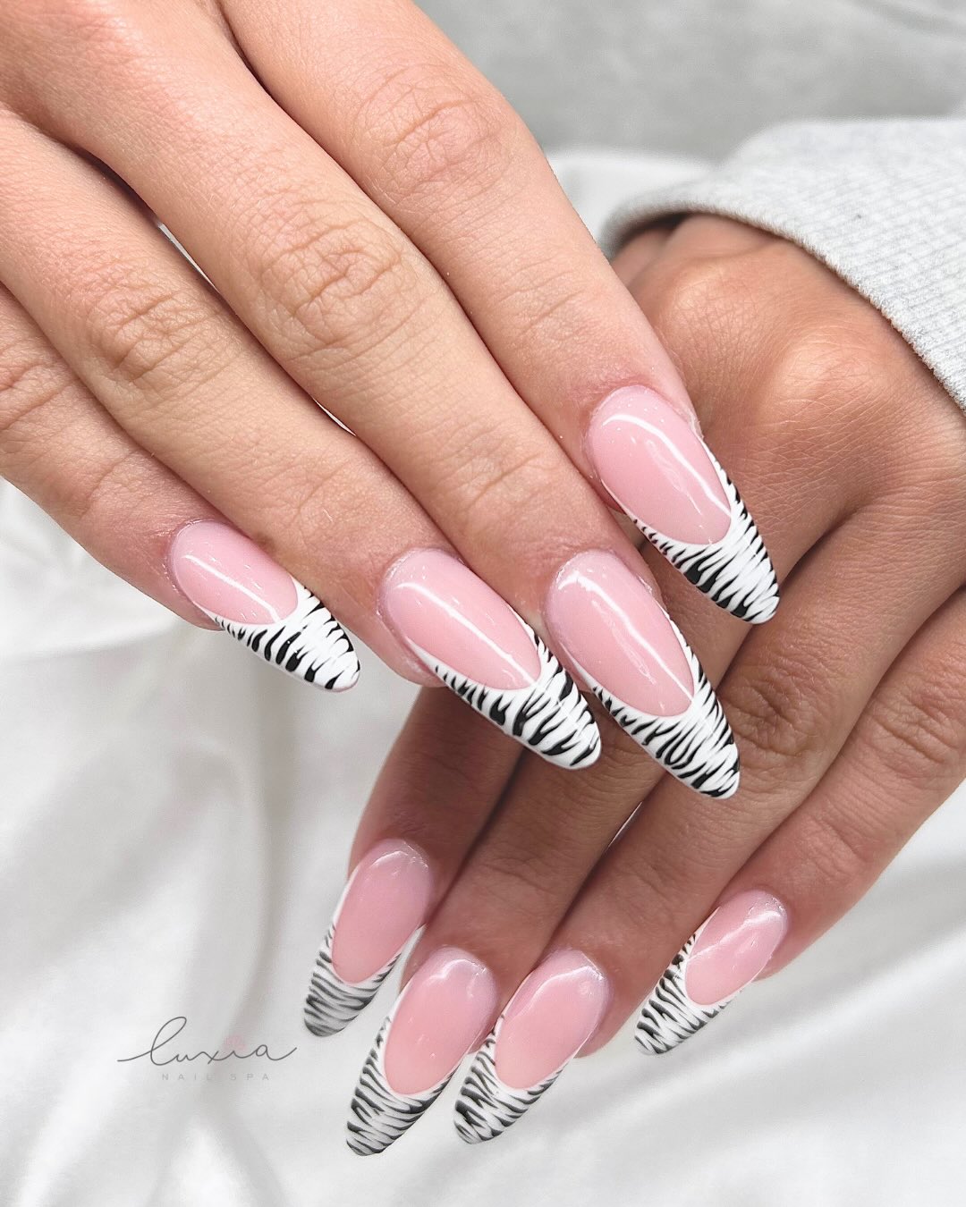 Nude coffin nails with zebra print French tips