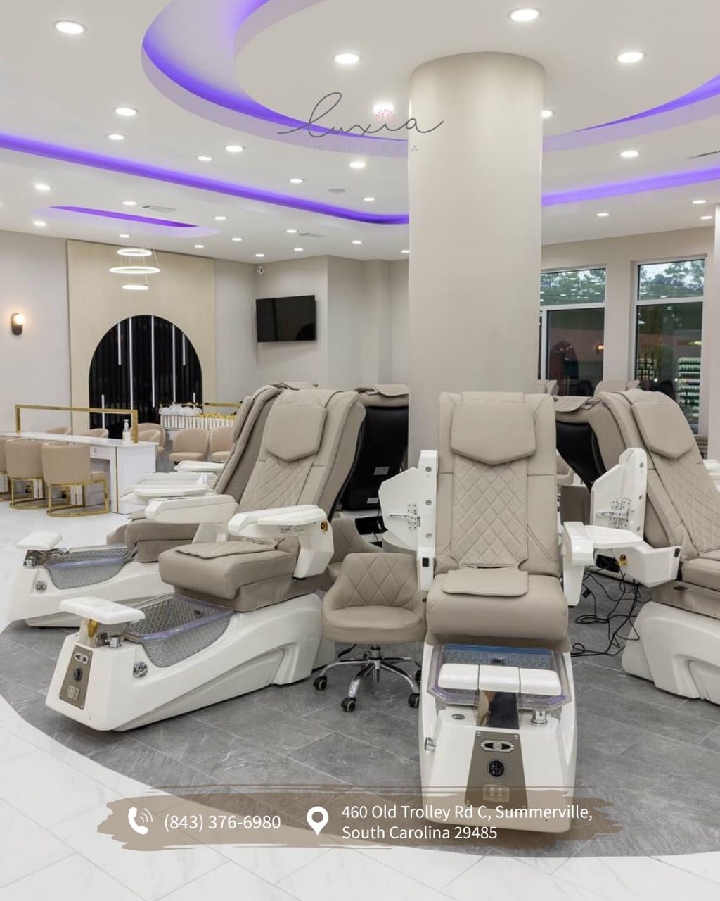 Luxia Nail Spa Summerville full salon showing violet ceiling and elegant stations