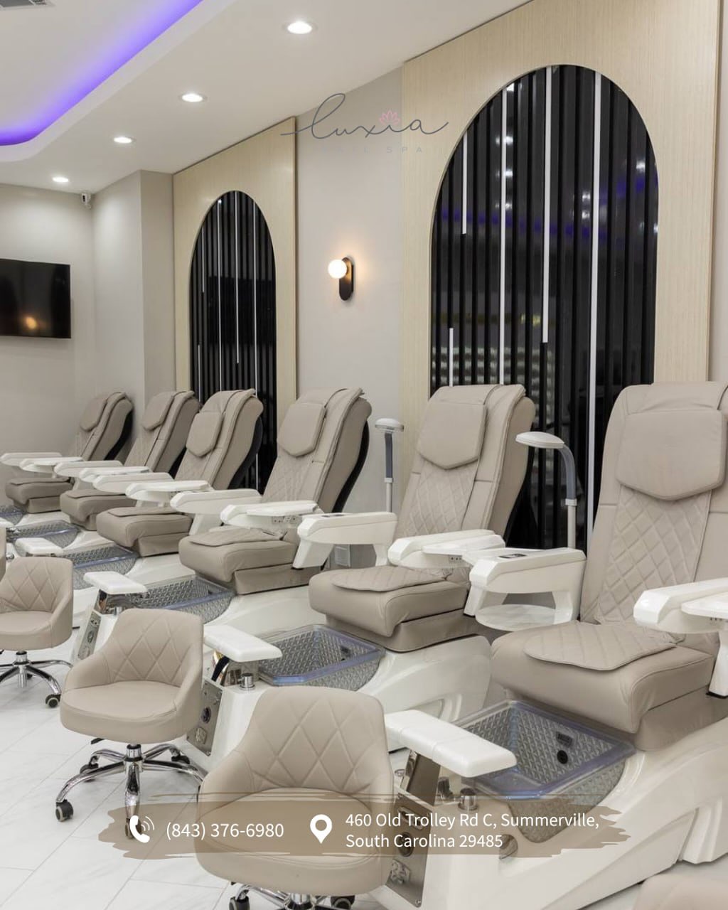 Pedicure area with purple LED ceiling and Luxia script logo